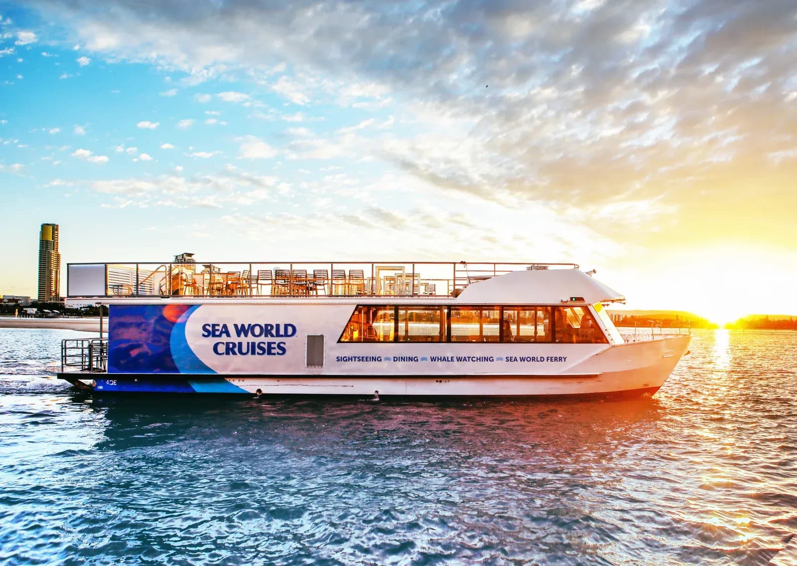 A Sea World Cruises vessel on the water at sunset